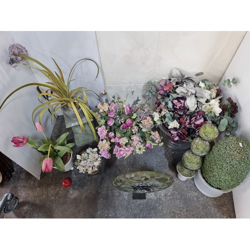 595 - A large selection of pretty artificial flowers including two unusual sculptural examples with hand l... 