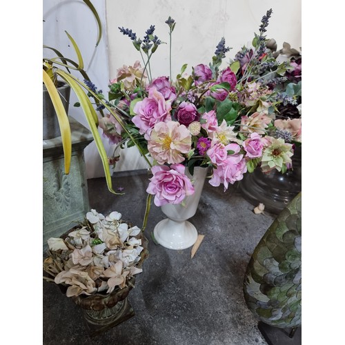 595 - A large selection of pretty artificial flowers including two unusual sculptural examples with hand l... 