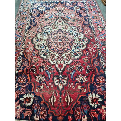 589 - Star Lot : A 100% hand knotted, Persian, floor rug. A striking woollen example in shades of blue, or... 