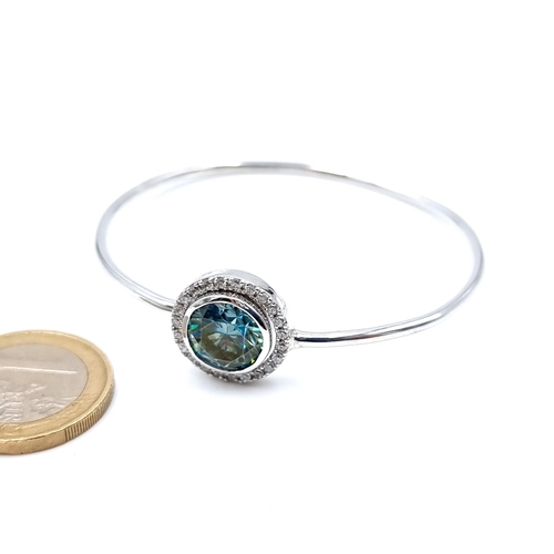 11 - A striking adjustable Ocean Blue Moissanite bracelet, with a large centre stone surrounded by a halo... 