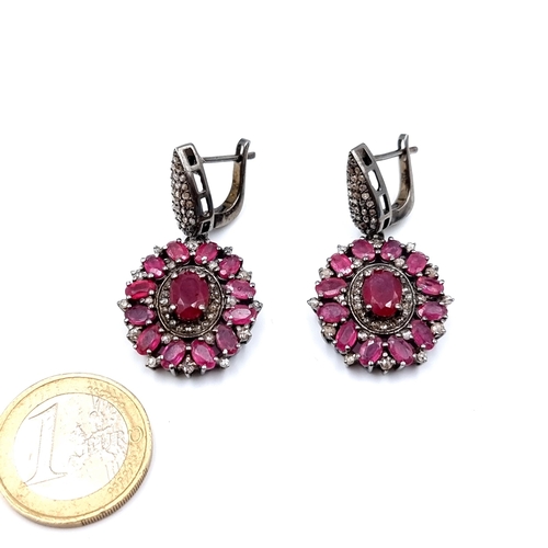 12 - A very fine pair of Rubyand diamond  drop earrings, set with 15 grams of Rubies and pave cut Diamond... 