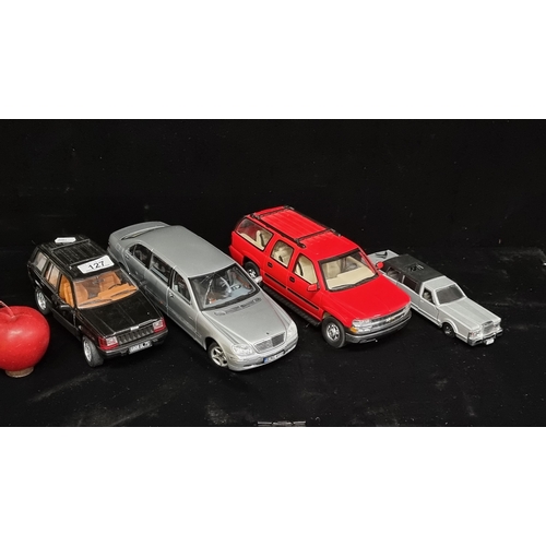 127 - A collection of four collectable model cars including a Mercedes Benz S-Class Pullman (1/18) by Sun ... 