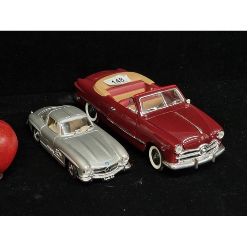 148 - Two collectible model cars including a Ford 1949 (1/18) by Mira, with realistic interiors and mechan... 