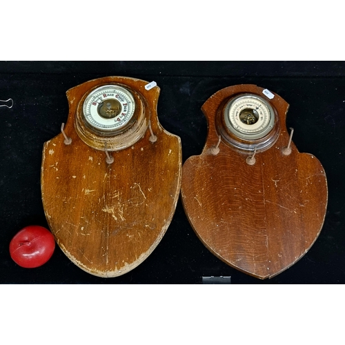 176 - Two antique Edwardian wall-mounting barometers on shields including one with a porcelain dial and or... 