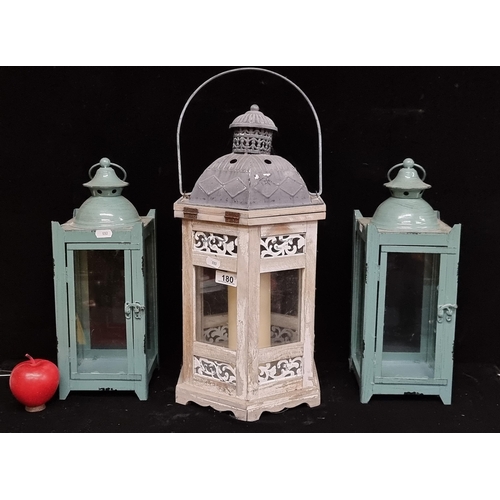 180 - An oversized hanging lantern with ashwood frame and pierced metal detail, complete with pillar candl... 