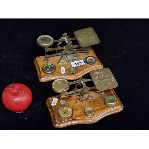 183 - A pair of Edwardian postal scales, mounted on a maple wood base and complete with a full set of weig... 