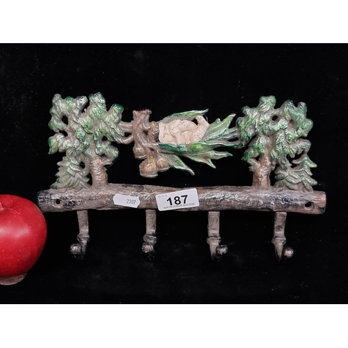 187 - A cast metal wall-mounting coat rack featuring a jungle scene with sleeping baby Tarzan. Hand-painte... 