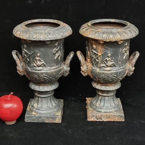 203 - A pair of very heavy cast metal urns featuring gadrooned detail and classical silhouettes. Ideal for... 