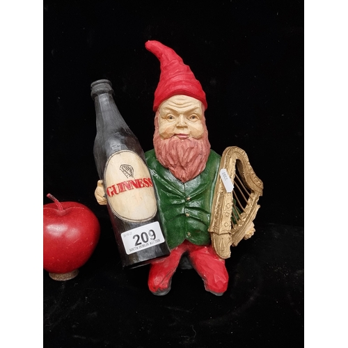 209 - A hand-painted Guinness leprechaun figure featuring the Irish harp and the Guinness bottle.