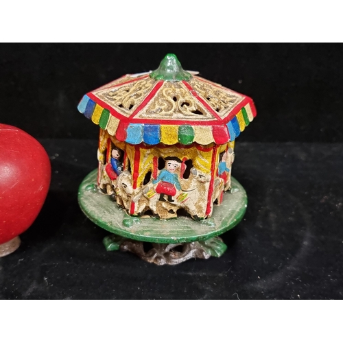 210 - A heavy cast metal carousel with rotating top and hand painted detail.