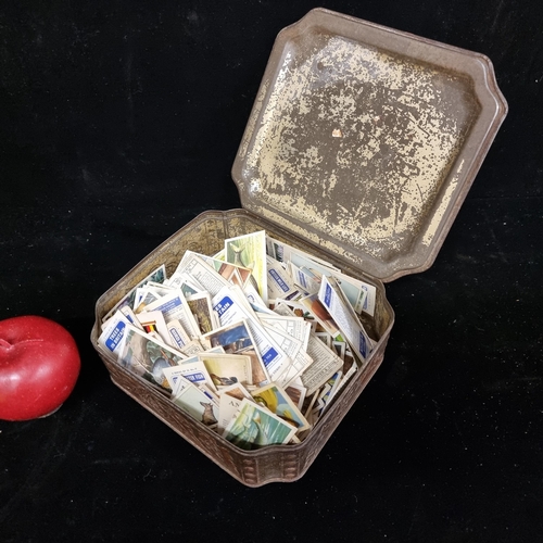 215 - A McFarlane Lang & Co biscuit tin filled with a  selection of vintage cigarette cards. Including Flo... 