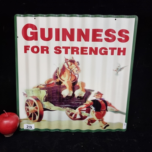 219 - A metal advertising sign for ''Guinness'' featuring the text ''Guinness For Strength'' on a corrugat... 