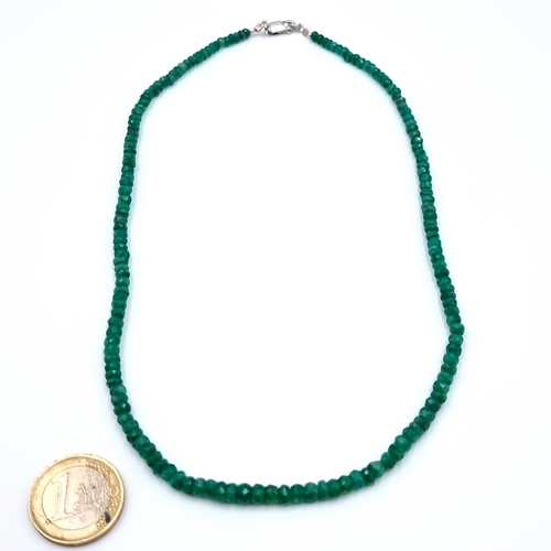 22 - An attractive facet cut 65 carat natural Emerald single strand necklace, set with a sterling silver ... 