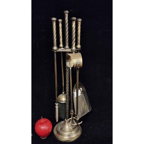 226 - A complete companion stand of four fire irons, crafted from brass with a simple spiral design to han... 