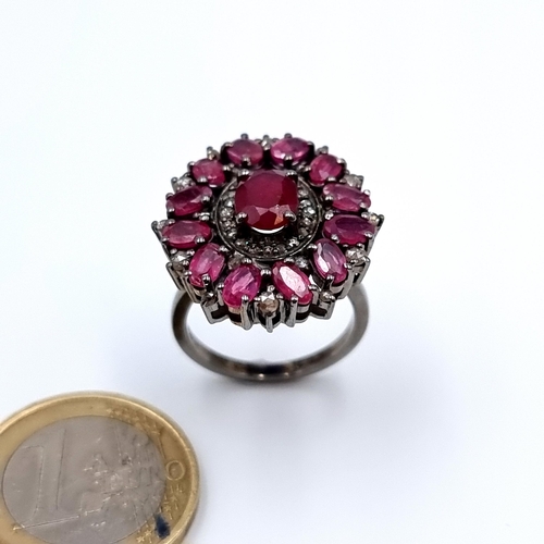 32 - A stunning round flower Ruby ring, with a Ruby and Diamond set halo which creates a beautiful rose c... 