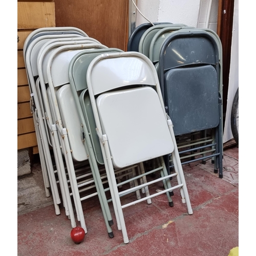 362 - A collection of fifteen sleek metal folding chairs, in shades of grey.