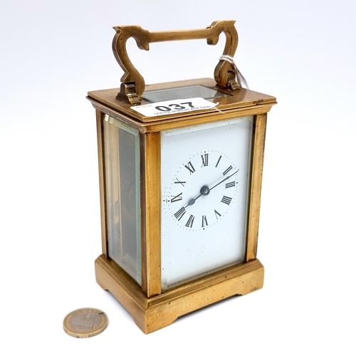37 - A good quality antique brass mechanical carriage clock, set with enamel Roman numerical dial with ob... 