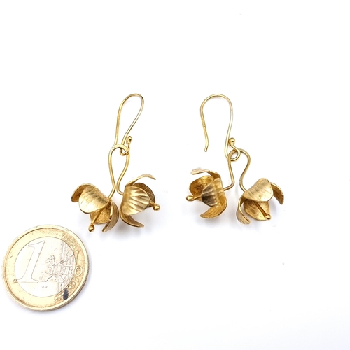 39 - A pair of silver gilt floral motif drop pendant earrings. Suitable for pierced ears.