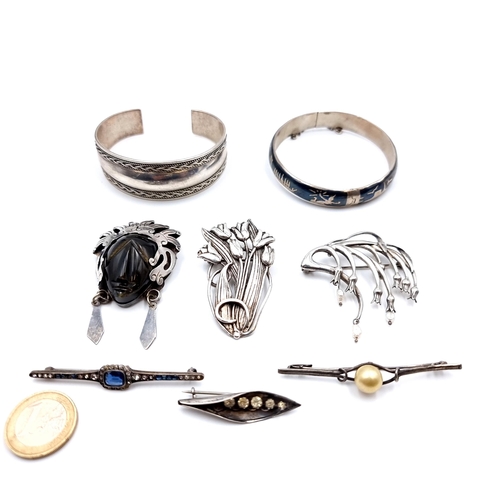 40 - A collection of eight sterling silver items, consisting of stone mounted brooches, a bangle and brac... 