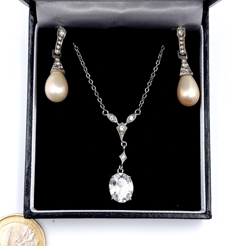 524 - A vintage sterling silver gem stone drop pendant necklace. Together with a pair of drop pendant earr... 