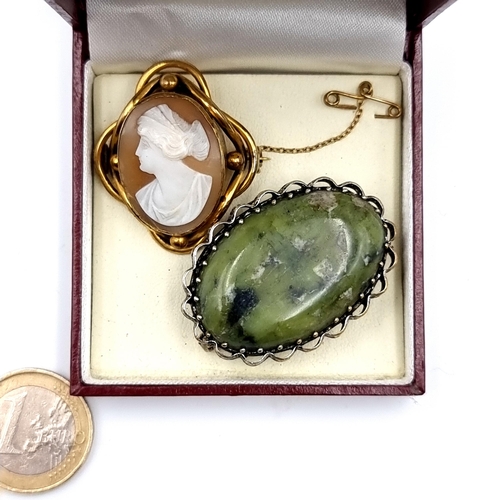 525 - Two antique brooches, the first is a Cameo with ornate gold mount and safety chain. Also, a sterling... 