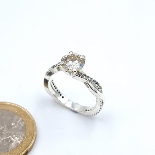 54 - A sterling silver White Moissanite ring, set with gem stones and a fine twist mount. Ring size: N. W... 