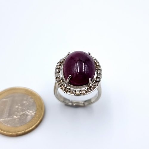 9 - Star Lot : A very pretty Cabochon cut Ruby and Diamond ring, with a super halo pave cut Diamond surr... 