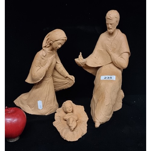 235 - A charming handmade terracotta nativity scene featuring the adoring Mary and Joseph, baby Jesus.