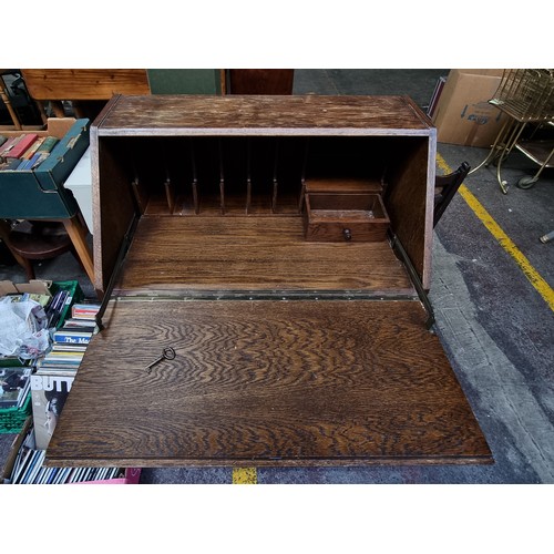 491 - A vintage writing desk with ornate carvings. The top opens to reveal eight pigeon holes and a drawer... 