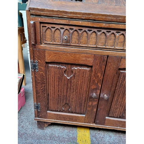 491 - A vintage writing desk with ornate carvings. The top opens to reveal eight pigeon holes and a drawer... 