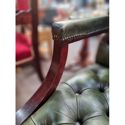 562 - Star Lot : A very handsome Chesterfield open armchair of generous proportions. With a curved wooden ... 