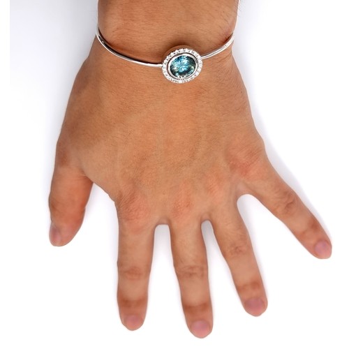 11 - A striking adjustable Ocean Blue Moissanite bracelet, with a large centre stone surrounded by a halo... 