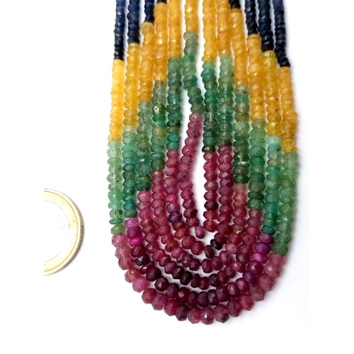 17 - An unusual six strand Ruby, Emerald and Sapphire art deco style necklace, which has a total length o... 