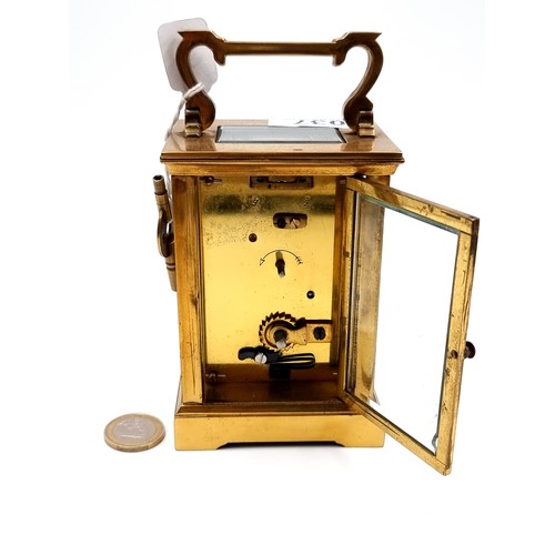 37 - A good quality antique brass mechanical carriage clock, set with enamel Roman numerical dial with ob... 