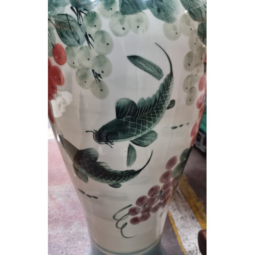 710 - Star lot : A huge Chinese urn vase with hand painted floral and koi motif. In super condition. 
MM: ... 