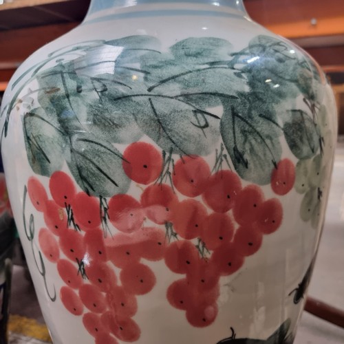 710 - Star lot : A huge Chinese urn vase with hand painted floral and koi motif. In super condition. 
MM: ... 