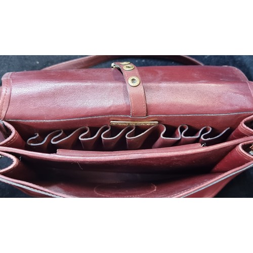 245 - A fabulous genuine leather satchel crossbody bag from Les Must de Cartier. In a maroon finish with p... 