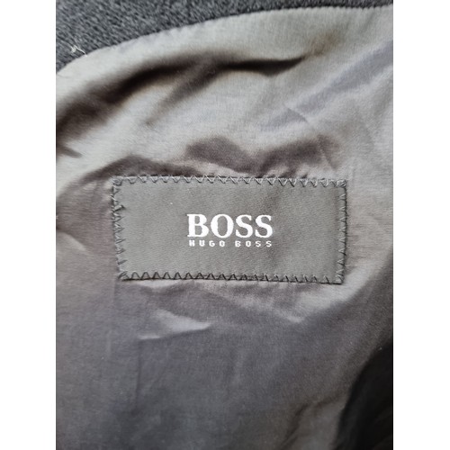 348 - A very elegant Hugo Boss, 100% wool men's overcoat in the 'De Tomaso' style. In black and size mediu... 