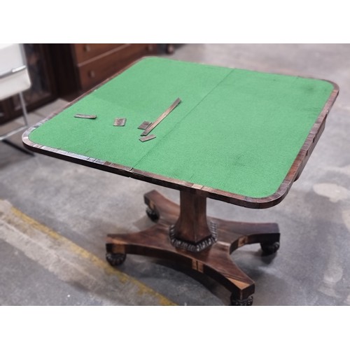 692 - A beautiful antique fold out games table on a quadroped pillar base with green felt to top. Some of ... 