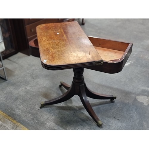 709 - A gorgeous Victorian mahogany fold out table on a turned wood quadroped pillar base, held on origina... 