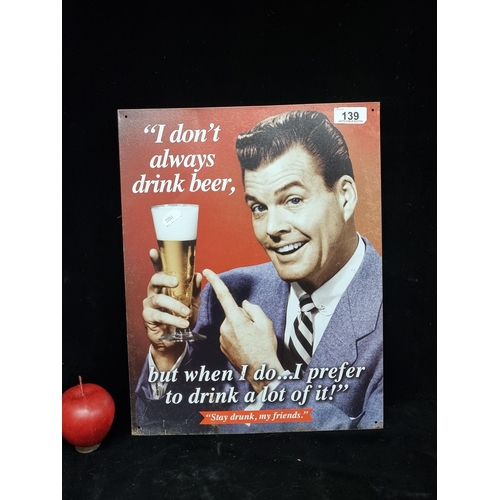 139 - A metal wall mountable advertising sign featuring a playful gentleman holding a pint aloft and text ... 