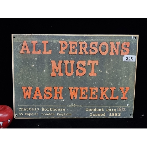 248 - A cast metal wall mounting sign reading ''All Persons Must Wash Weekly'' on order of the Chattels Wo... 