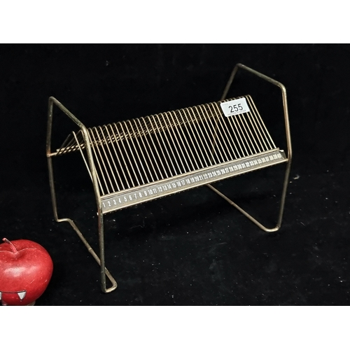 255 - A brilliant 1970s vinyl single rack with space for forty singles. In a gold finish.