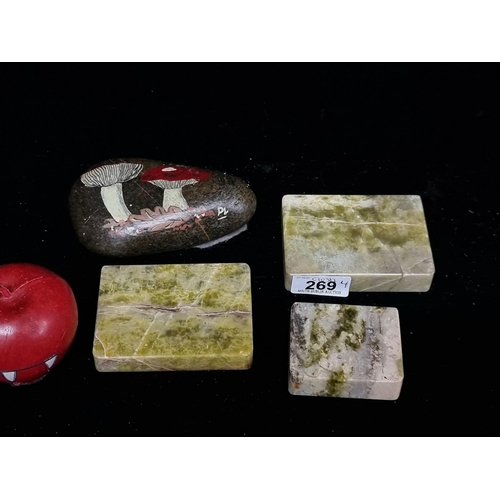 269 - Three Connemara marble paperweights or stands along with a charming painted stone paperweight with t... 