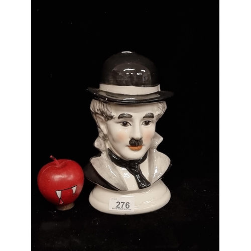 276 - A vintage porcelain bust of Charlie Chaplin in black and white with his trademark hat and moustache.