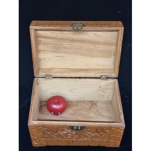 281 - A charming large vintage hand carved wooden box featuring figurative and floral motifs with brass cl... 