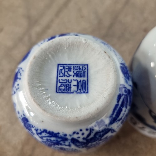 275 - Four pieces of Chinese porcelain including two tea cups, a condiment dish and a saucer, all in blue ... 