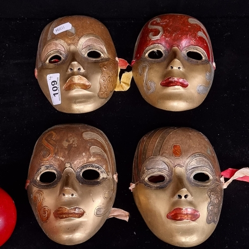 109 - Four heavy striking brass theatre masks with various hand painted and finely incised decoration. H16... 