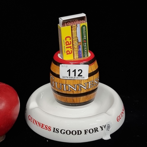 112 - A super Guinness branded ashtray with a central match holder in a form of a barrel.