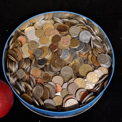 121 - A tin filled with an absolutely huge  collection of coins. unchecked